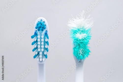 Image of used old and new toothbrushes isolated on a white background