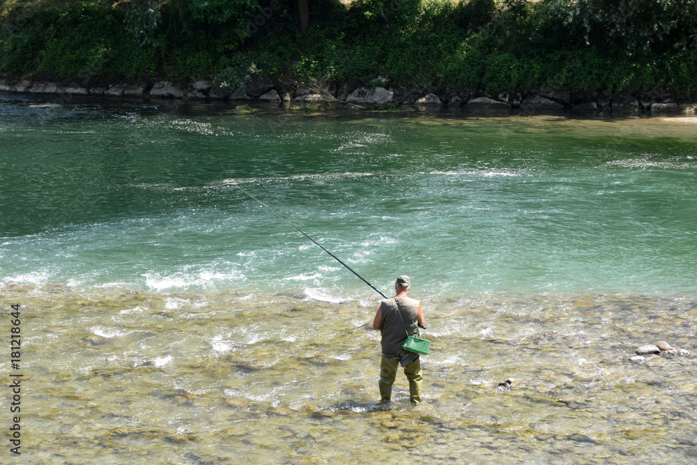 Fisherman in a mountain river in Upper Lombardy - Italy Fisherman in a mountain river in Upper Lombardy - Italy