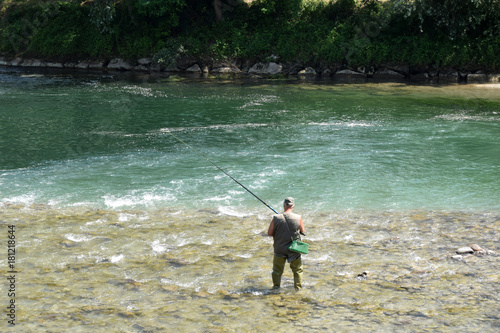 Fisherman in a mountain river in Upper Lombardy - Italy