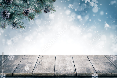 Christmas background with spruce branches and cones with snow flakes and copyspace for text.