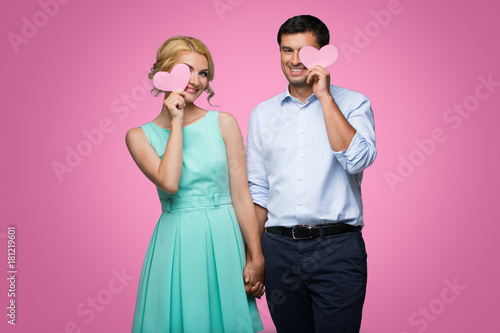Beautiful couple holding pink hearts