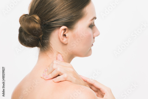 Young woman having stiff shoulders.