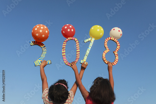 Cheerful Girls welcoming happy new year 2018