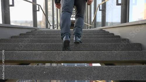 man's feet walking up stairs