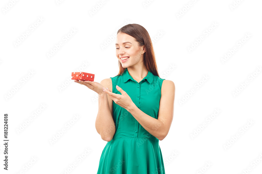 Studio portrait of beautiful young woman holding small gift box on white background Studio portrait of beautiful young woman holding small gift box on white background