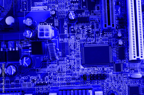 Integrated semiconductor microchip on blue circuit board representative of the high tech industry and computer science