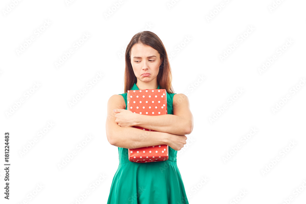 Portrait of young woman holding gift box wrapped in red paper Portrait of young woman holding gift box wrapped in red paper