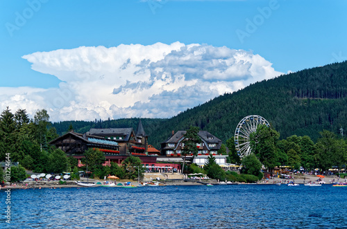 Wallpaper Mural Touristic resorts at the lake Titisee in Black forest national park Germany (Schwarzwald). Panoramic view at the traditional buildings and Ferris Wheel at the famous promenade. Torontodigital.ca