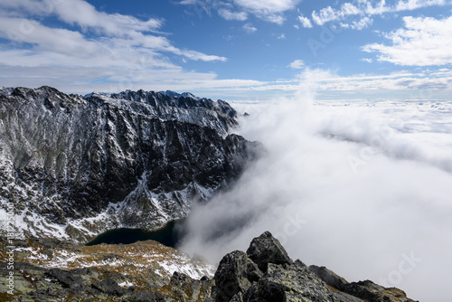 mountain tops in autumn covered in mist or clouds