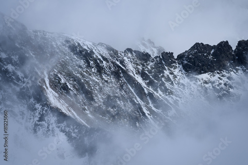 mountain tops in autumn covered in mist or clouds