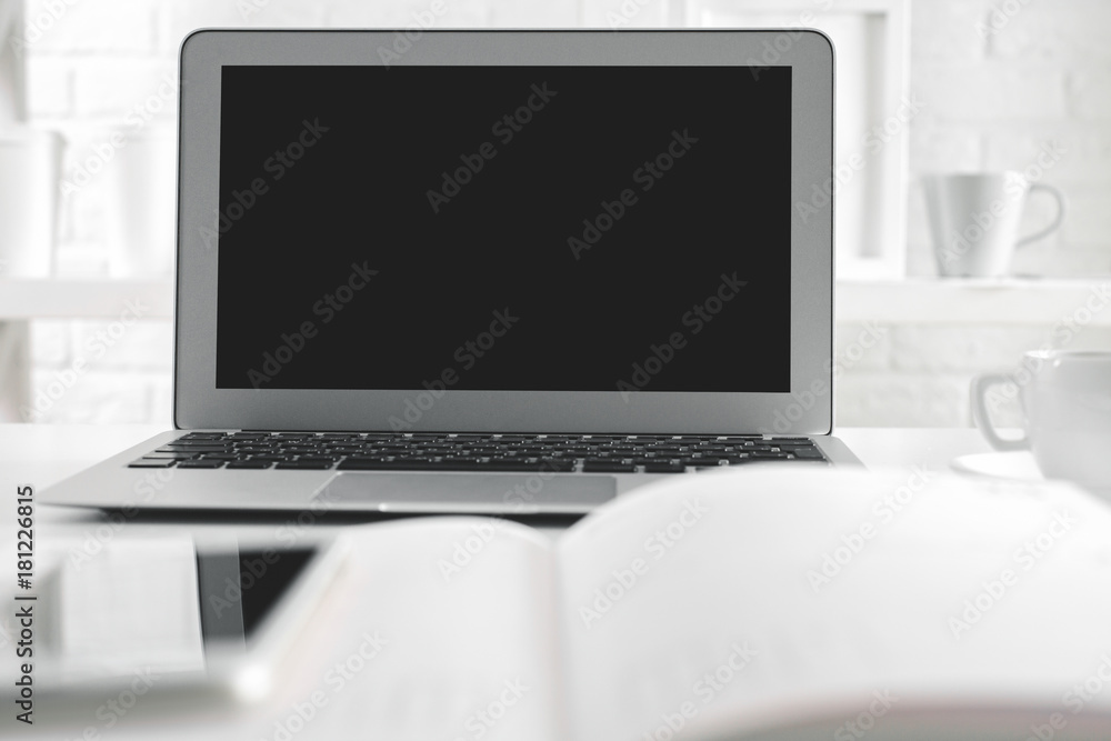 Hipster office table with empty laptop screen Hipster office table with empty laptop screen