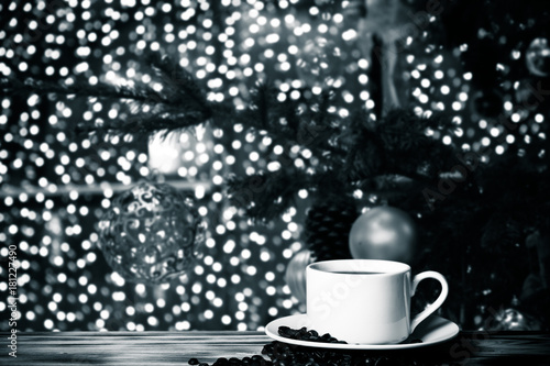 Coffee in a cup on wooden table opposite a defocused background. Collage. Selective focus. Toned