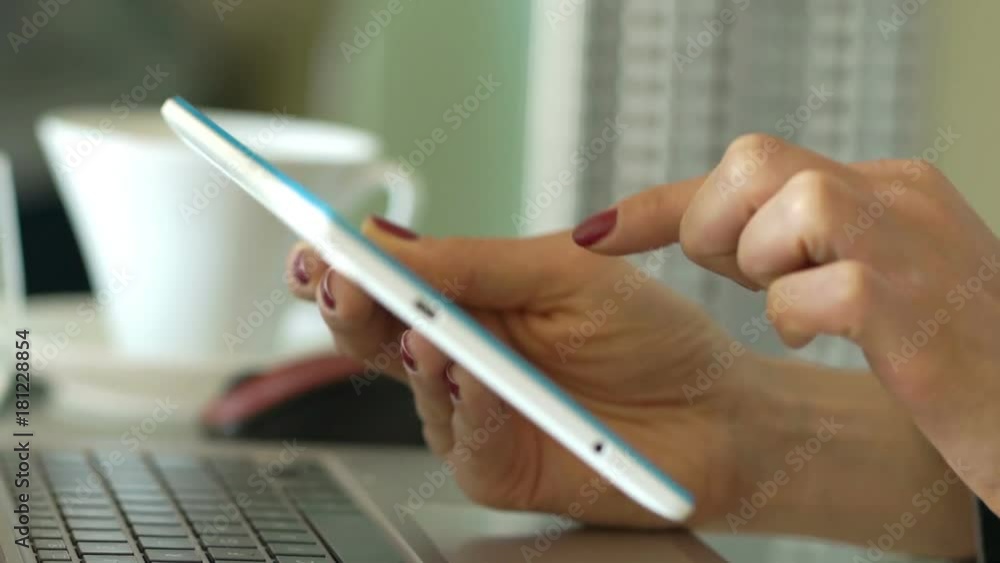 Businesswoman using tablet computer sitting by table in office
Businesswoman using tablet computer sitting by table in office