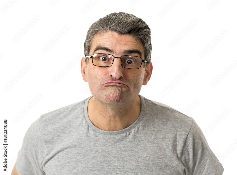 Obraz premium portrait of 40s weird and nerd man on glasses in ridiculous silly and stupid face expression looking at camera isolated on white