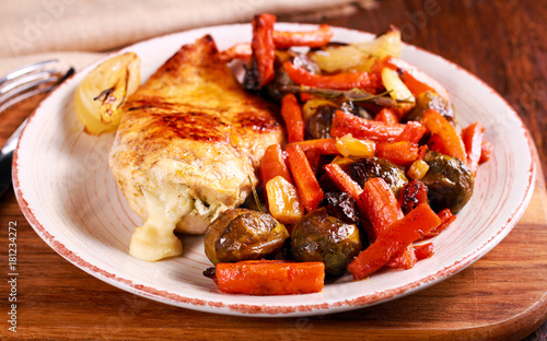 Roast vegetables and chicken breast stuffed with pesto and mozzarella