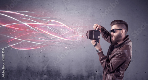 Elegant hipster with camera and bright lines