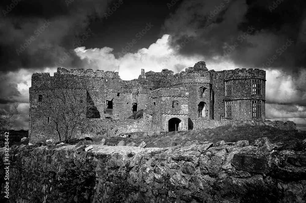 Monochrome image of Carew Castle in Pembrokeshire, Wales UK which is a 12th century ruin