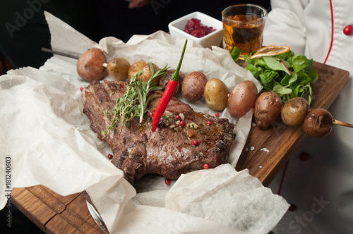 grilled beef steak with vegetables on plate photo