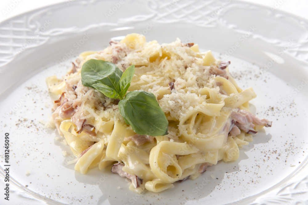 Carbonara with cheese and bacon decorated with basil Carbonara with cheese and bacon decorated with basil