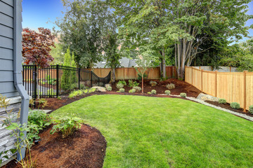 Acrylglasbilder Pistache Nice fenced backyard with new planting beds  © Iriana Shiyan