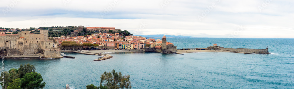 Panoramic view to picturesque old house facades, Collioure castle, bell tower of Notre Dame des Anges church and lighthouse