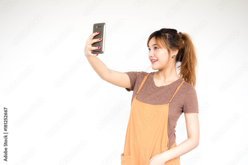 Beautiful young adult thai chinese bronze hair using her smart phone Selfie Beautiful young adult thai chinese bronze hair using her smart phone Selfie