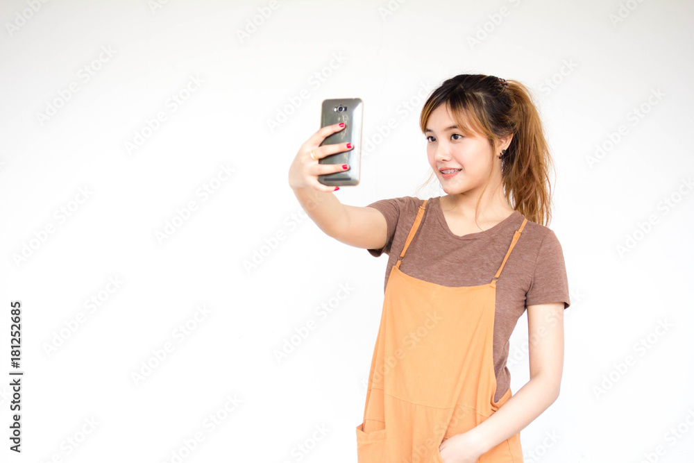 Beautiful young adult thai chinese bronze hair using her smart phone Selfie Beautiful young adult thai chinese bronze hair using her smart phone Selfie