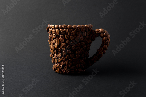 Coffee cup / Creative concept photo of a cup made of coffee on black background.