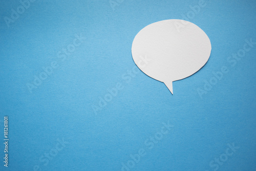 Blank speech bubble on blue paper background.