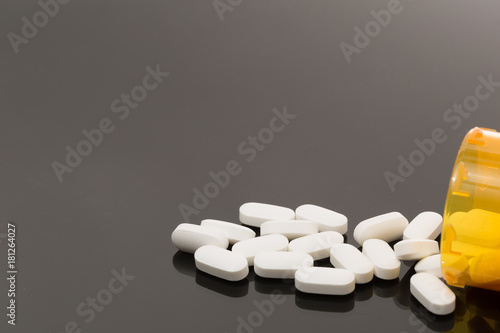 opioid white pills spilled out on table for health addiction pain medicine photo