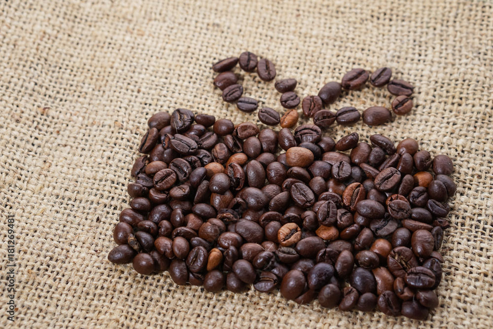 Present made of coffee beans on sackcloth Present made of coffee beans on sackcloth