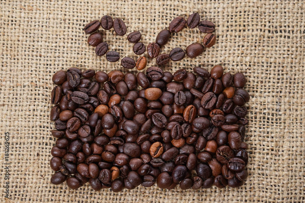 Present made of coffee beans on sackcloth Present made of coffee beans on sackcloth