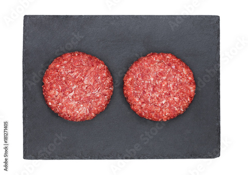 Raw fresh beef burgers on stone plate