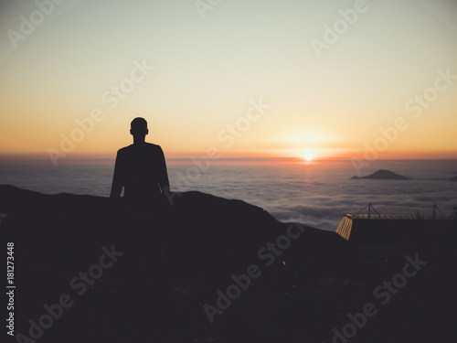 man standing sunset clouds mountains sky skyline
