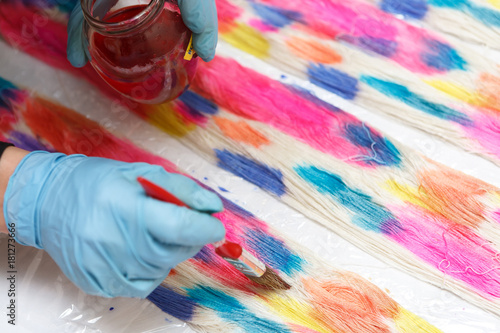 Canvas Print Hands in gloves in yarn dyeing process