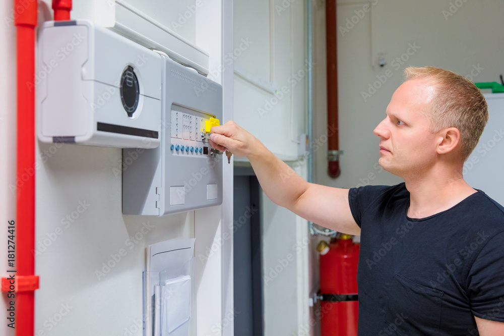 IT Engineer Opening Fire Panel In Server Room