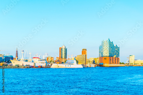 Modern yachts in the port of hamburg with the elbphilharmonie building, Germany. photo