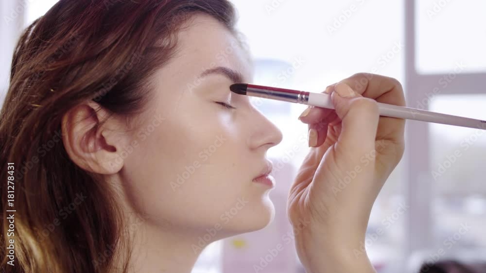 Makeup artist applies eyes shadow Makeup artist applies eyes shadow