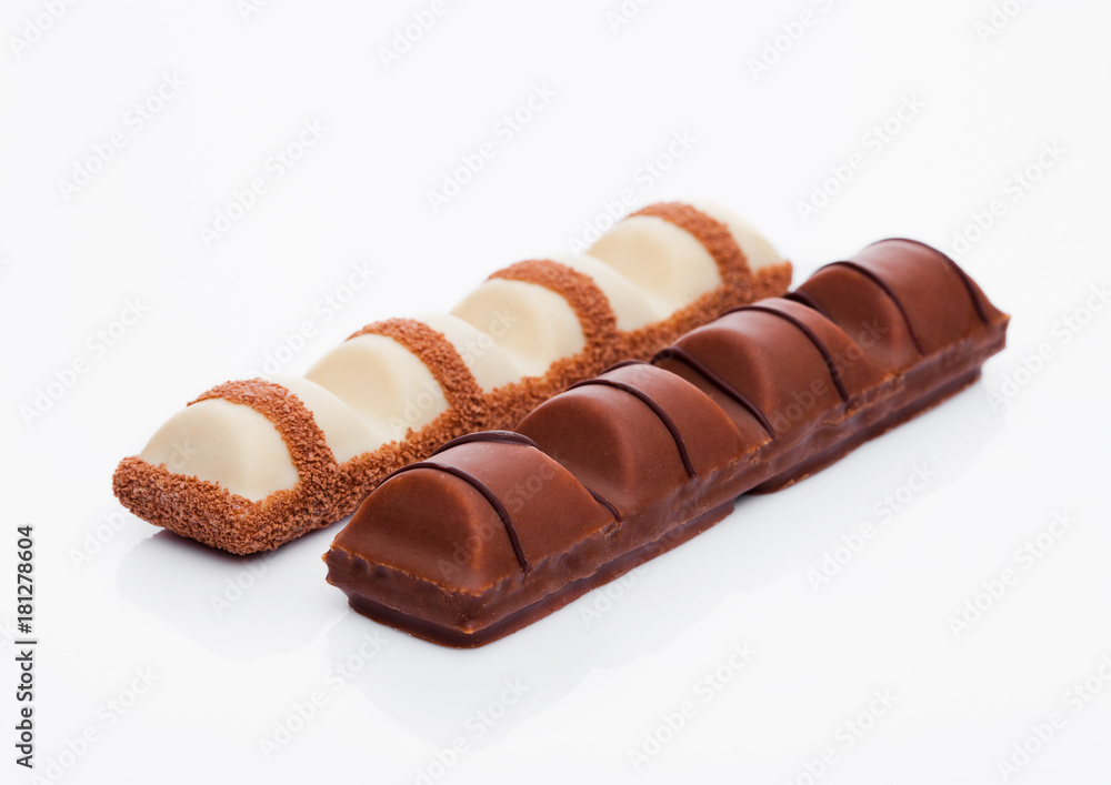 Milk and white chocolate sweet bars on white Milk and white chocolate sweet bars on white