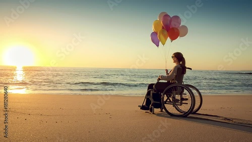 Happy woman on the beach holding ballons
