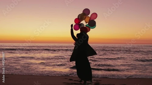 Woman walking with balloons