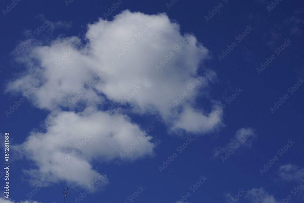 Fototapeta premium Gorgeous white clouds in the blue sky. There is space in the upper right and bottom corner.