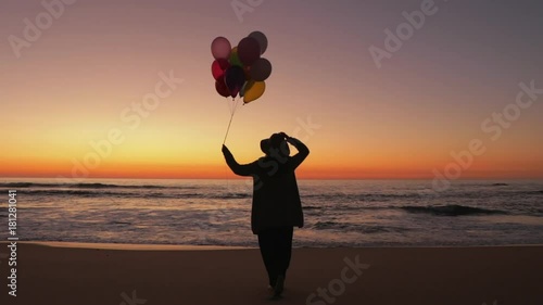 Woman walking with balloons