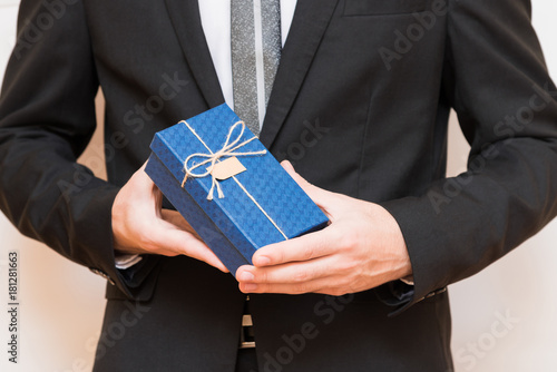 A man holding a gift box in his hands