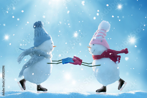 Merry christmas and happy new year greeting card .Two ice skating snowmen