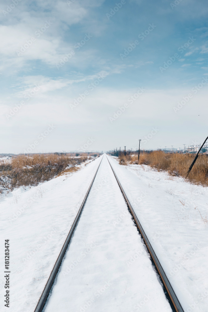 Railroad tracks covered in snow.