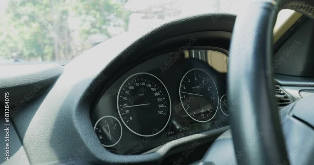 Closeup of car dashboard with speedometer and steering wheel, shot in 4k resolution on highway Closeup of car dashboard with speedometer and steering wheel, shot in 4k resolution on highway