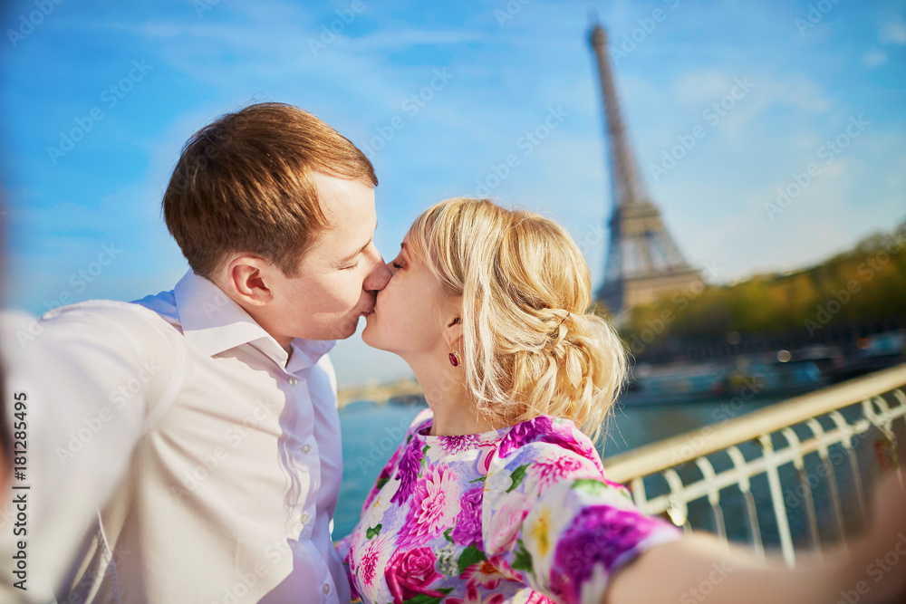 Happy couple taking selfie near the Eiffel tower Happy couple taking selfie near the Eiffel tower