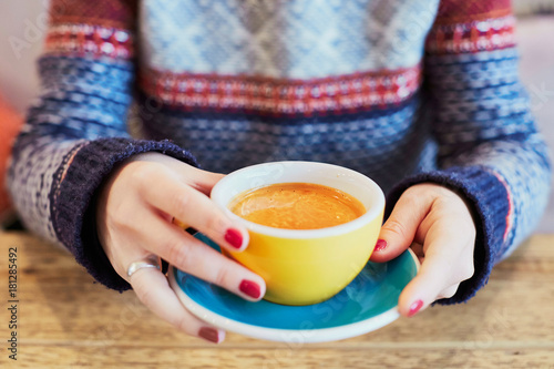 Woman hands with cup of hot coffee