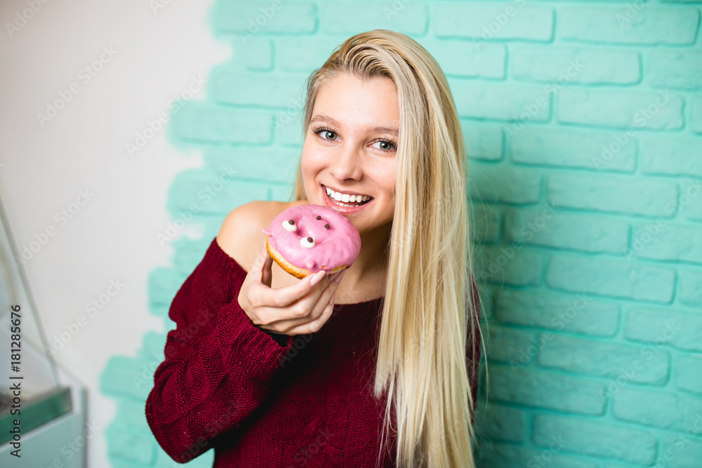 Beautiful young woman enjoying in delicious glazed and decorated donuts. Beautiful young woman enjoying in delicious glazed and decorated donuts.